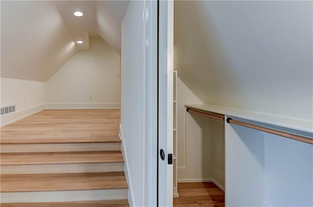 2207 W 71st St, Prairie Village, KS 66208 - staircase with lofted ceiling, recessed lighting, wood finished floors, and baseboards