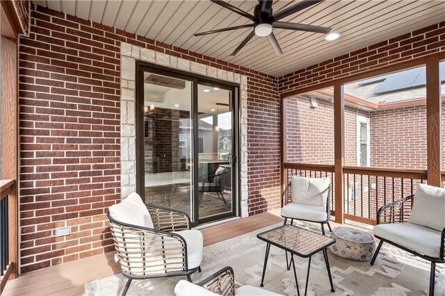 sunroom featuring ceiling fan and a skylight