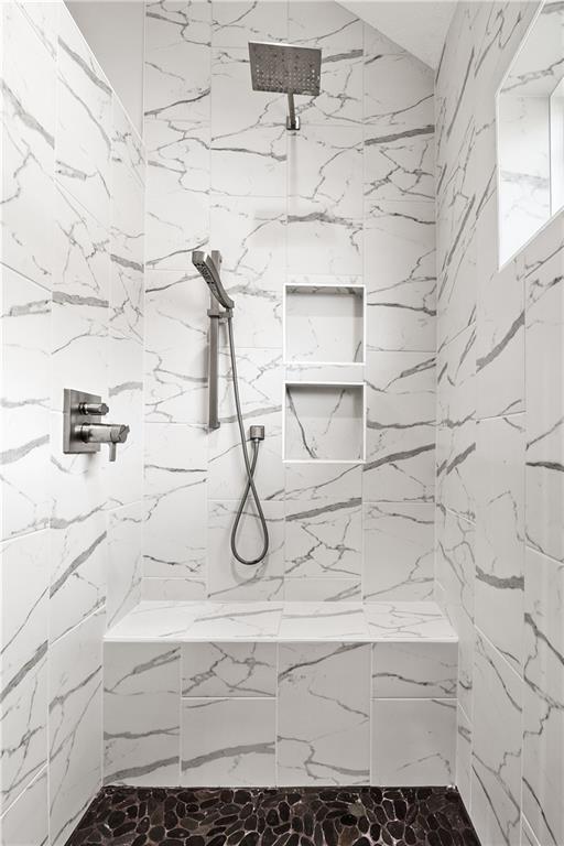 bathroom with tiled shower