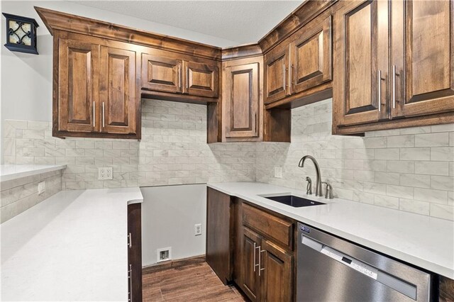 kitchen with dishwasher, backsplash, sink, and dark hardwood / wood-style floors