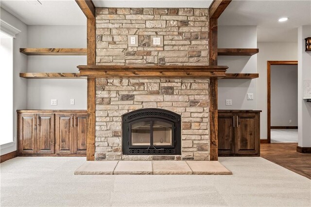 interior details with a stone fireplace and hardwood / wood-style flooring