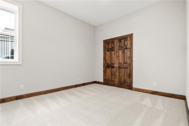 carpeted empty room with a wealth of natural light