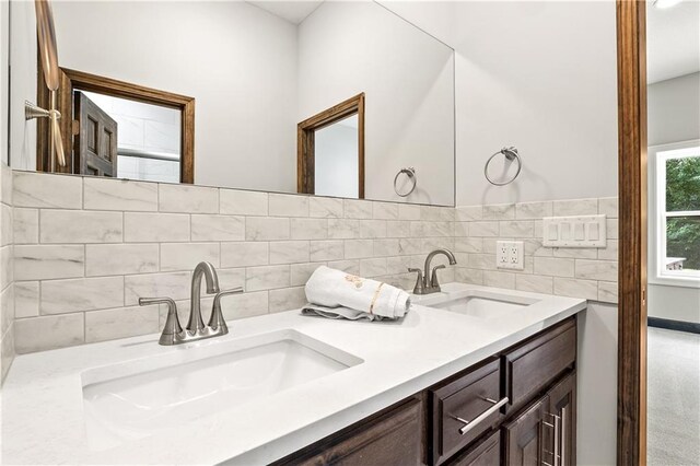 bathroom with decorative backsplash and vanity