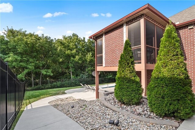 view of side of home featuring a patio area