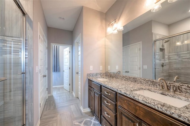 bathroom with a shower with door and vanity