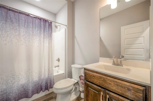 full bathroom featuring toilet, vanity, and shower / bath combo with shower curtain