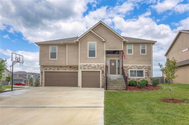 view of front of house featuring a garage and a front lawn