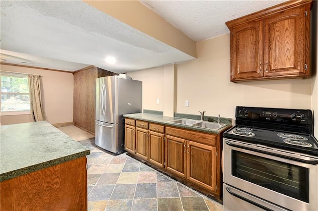 kitchen with sink, stainless steel appliances, and a textured ceiling