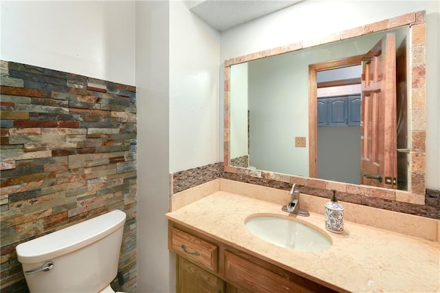 bathroom featuring toilet and vanity