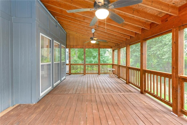 unfurnished sunroom with vaulted ceiling, wood ceiling, and ceiling fan