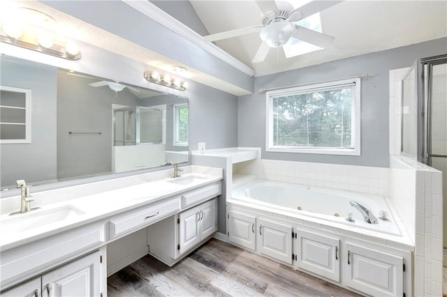 bathroom with vanity, ceiling fan, hardwood / wood-style flooring, and shower with separate bathtub