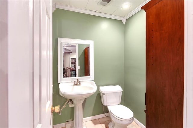 bathroom with toilet, tile patterned floors, and ornamental molding