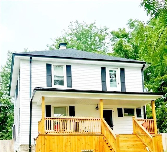 view of front of home with a porch and a chimney