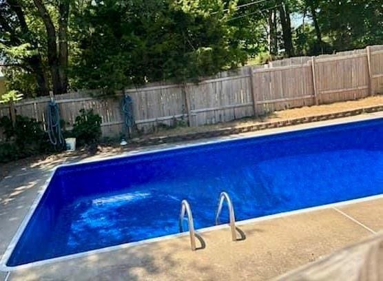 view of swimming pool with a fenced in pool and a fenced backyard