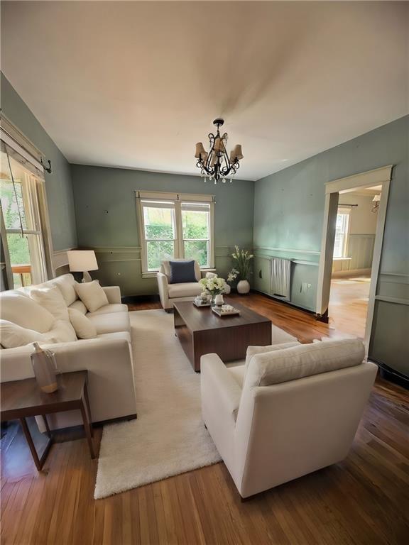 living area featuring a chandelier and wood finished floors