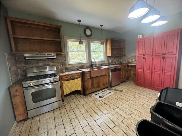 kitchen with light wood-style flooring, open shelves, under cabinet range hood, backsplash, and appliances with stainless steel finishes