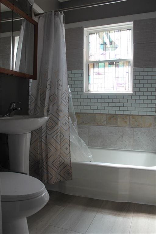 bathroom with toilet, tile patterned floors, and shower / bath combo