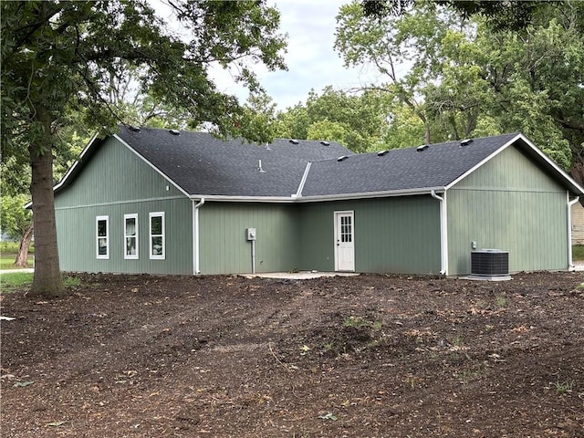 rear view of property with cooling unit