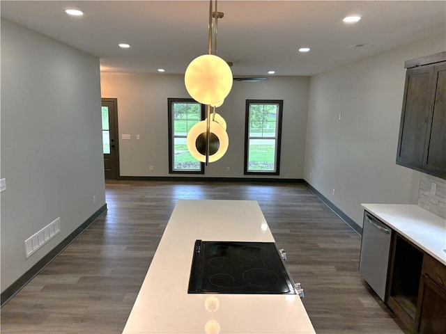 kitchen featuring dishwasher, pendant lighting, dark brown cabinets, black electric stovetop, and dark hardwood / wood-style floors