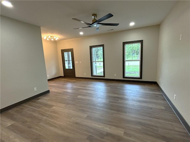 unfurnished room featuring dark hardwood / wood-style floors and ceiling fan