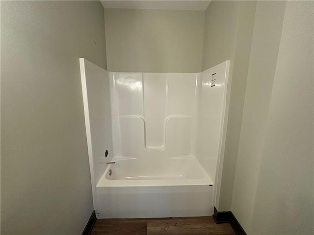 bathroom with shower / bathing tub combination and hardwood / wood-style flooring