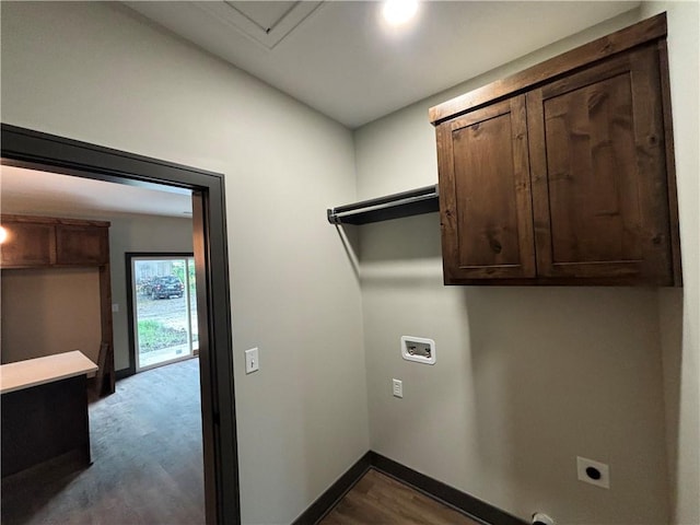 washroom with light hardwood / wood-style flooring, hookup for an electric dryer, washer hookup, and cabinets