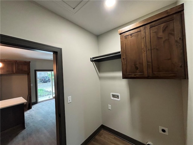 laundry room featuring cabinets, electric dryer hookup, washer hookup, and light hardwood / wood-style flooring