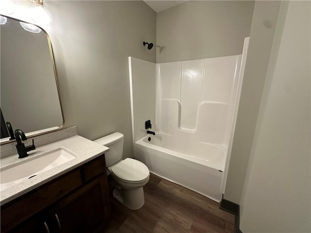 full bathroom with shower / tub combination, hardwood / wood-style floors, vanity, and toilet