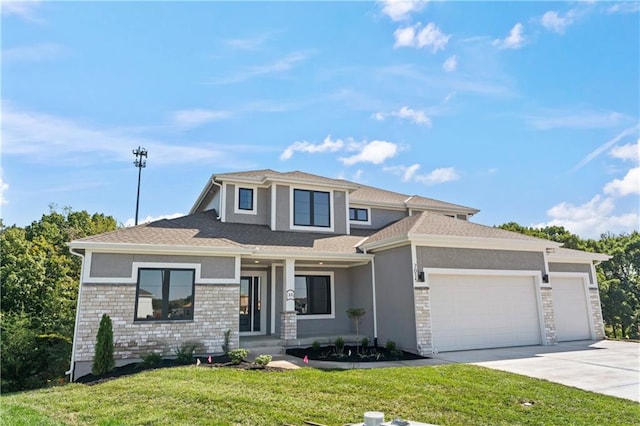 view of front of property with a garage and a front lawn