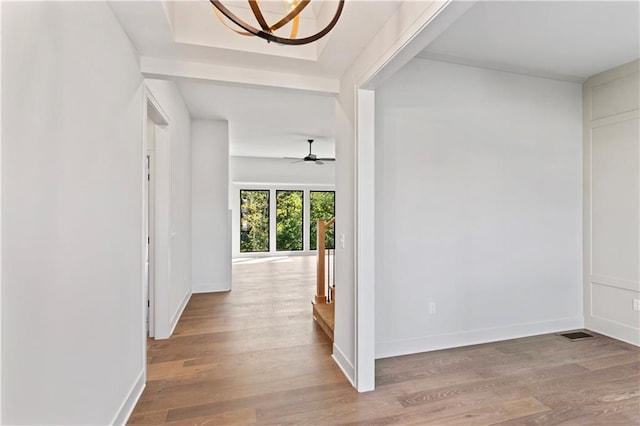 hall featuring a chandelier and hardwood / wood-style floors