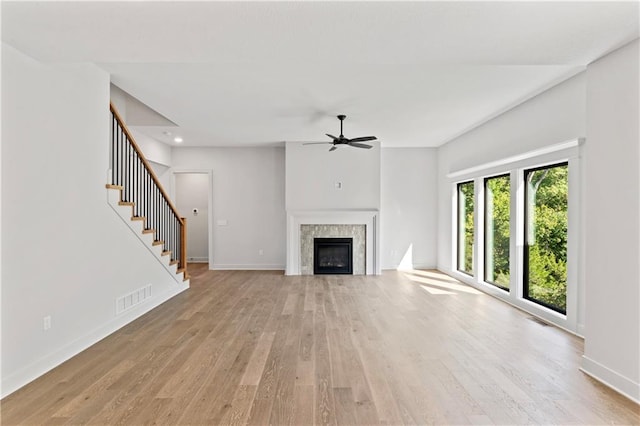 unfurnished living room featuring light wood-type flooring and ceiling fan