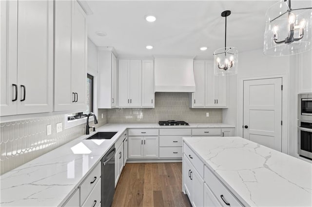 kitchen with decorative light fixtures, dark wood-type flooring, sink, and white cabinetry