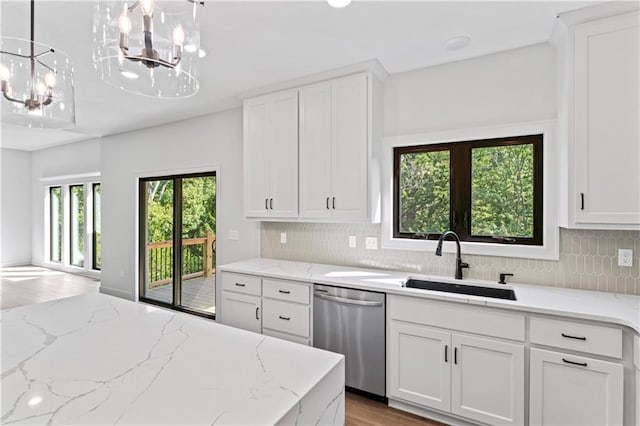 kitchen featuring a notable chandelier, dishwasher, plenty of natural light, and sink