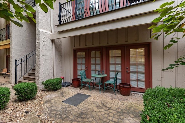 entrance to property with a patio area and french doors