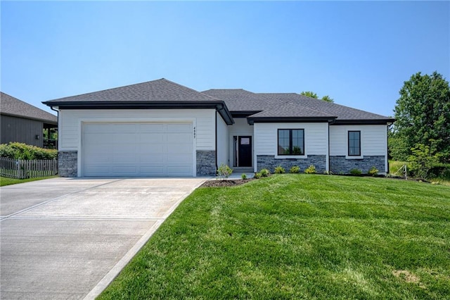 4805 NE 62nd St, Kansas City, MO 64119 - prairie-style home featuring stone siding, an attached garage, and driveway