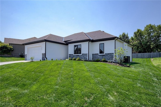 4805 NE 62nd St, Kansas City, MO 64119 - prairie-style home featuring stone siding, concrete driveway, and an attached garage