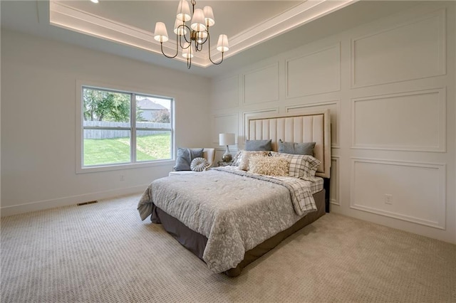 4805 NE 62nd St, Kansas City, MO 64119 - bedroom featuring light carpet, a chandelier, and a raised ceiling