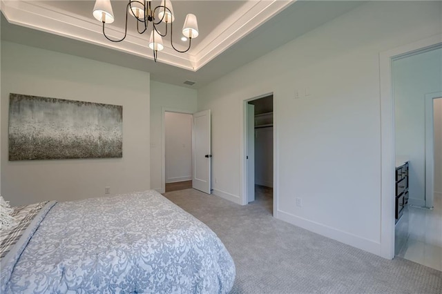 4805 NE 62nd St, Kansas City, MO 64119 - carpeted bedroom with a chandelier, a spacious closet, and a raised ceiling