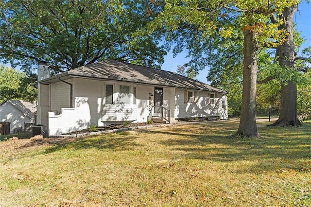 ranch-style home with central AC unit and a front lawn