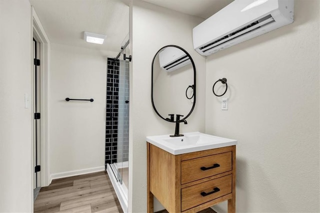 bathroom with vanity, hardwood / wood-style flooring, an AC wall unit, and a shower