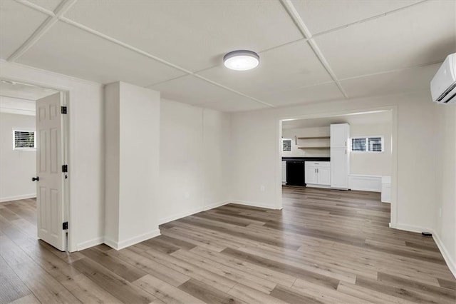 unfurnished living room with a wall mounted AC and light wood-type flooring