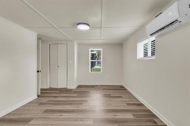 interior space featuring light hardwood / wood-style floors and a wall unit AC