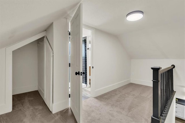 bonus room with light carpet and lofted ceiling