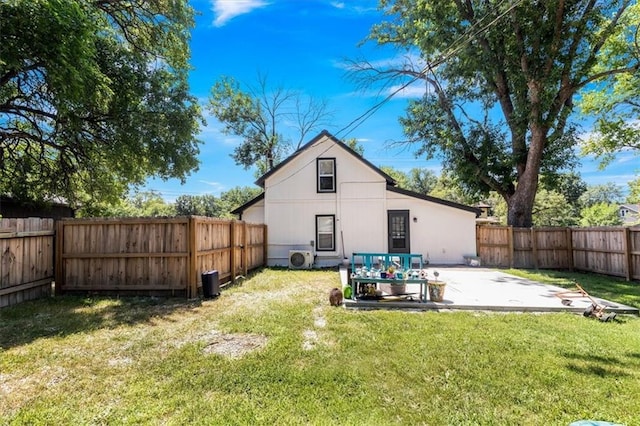 back of house with a yard and a patio