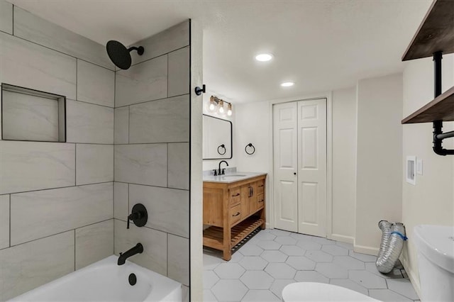 bathroom with vanity, tile patterned flooring, and tiled shower / bath