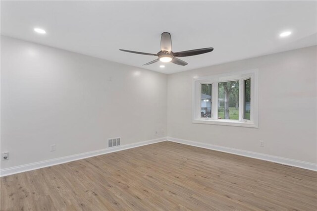 empty room with light hardwood / wood-style flooring and ceiling fan