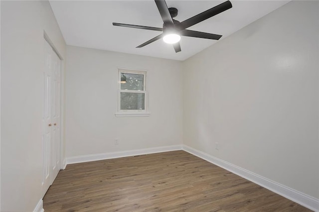 unfurnished room with ceiling fan, baseboards, and wood finished floors