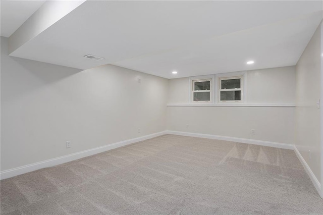 finished below grade area with visible vents, recessed lighting, carpet, and baseboards