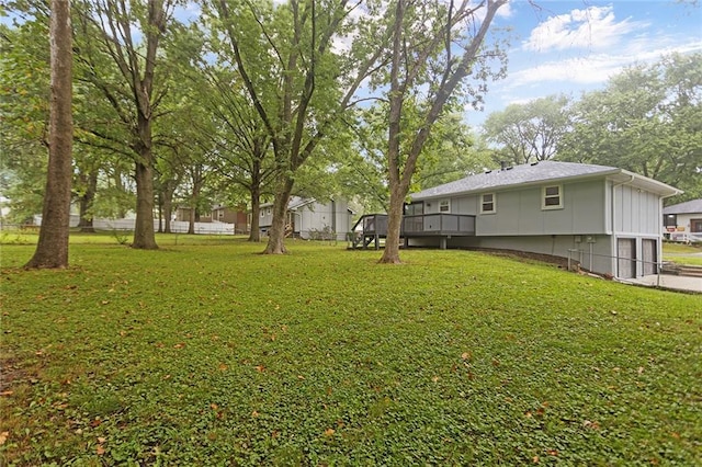 view of yard with an attached garage and fence