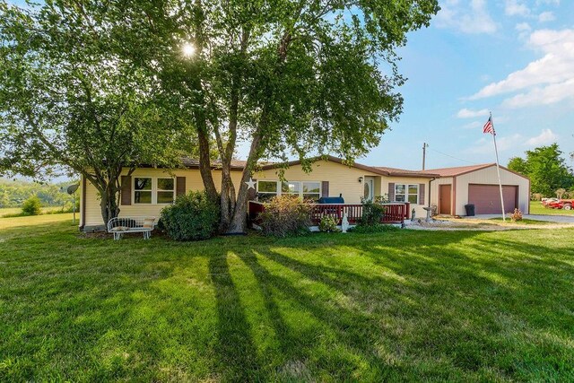 15124 NW County Road 14001st Rd, Drexel, MO 64742 - rear view of house featuring driveway, an attached garage, an outdoor structure, a yard, and a wooden deck